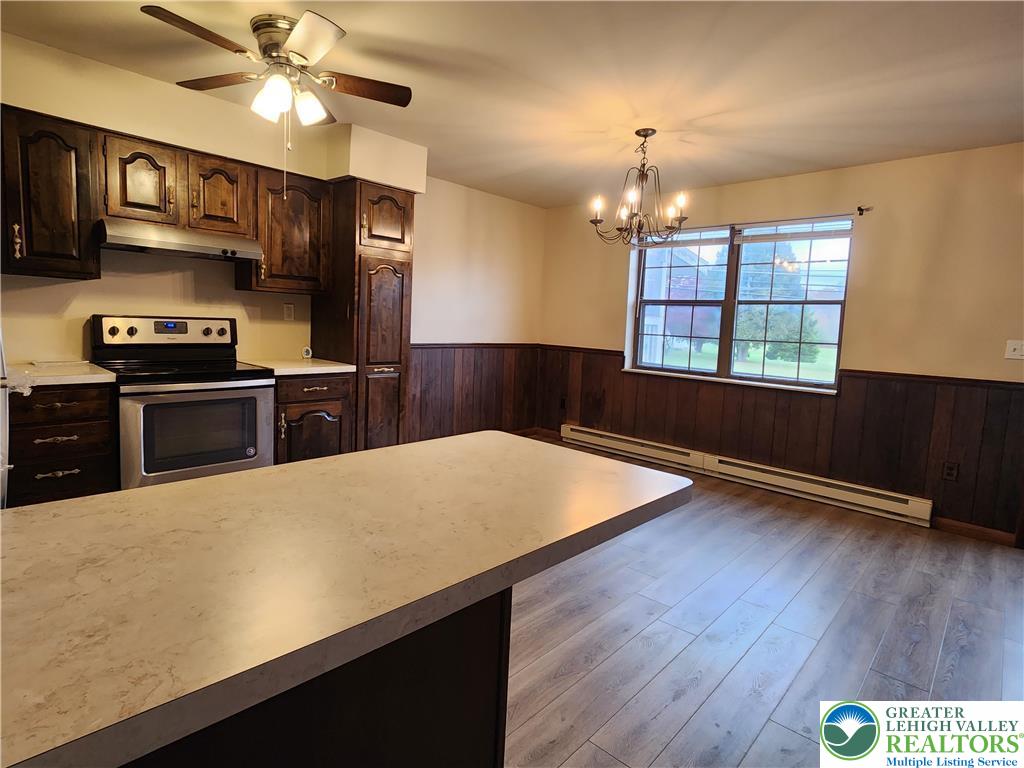 614 East Main Street Bath, PA 18014 - Photo 4 of 8 a kitchen with stainless steel appliances a stove a refrigerator a sink and dishwasher with wooden floor