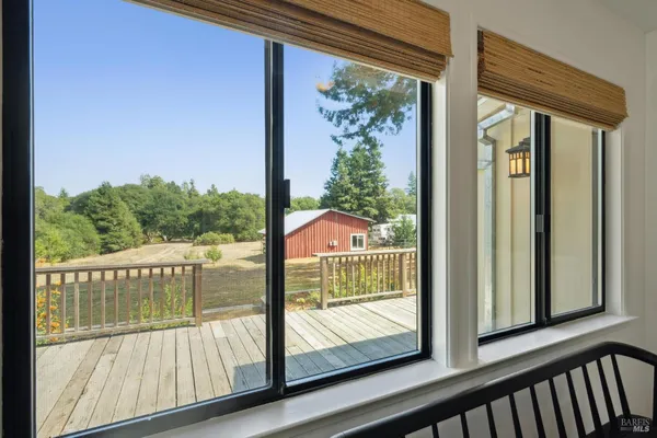 a view of a room with wooden floor and iron fence