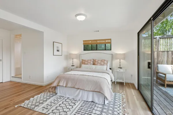 a bedroom with a bed and a painting on the wall