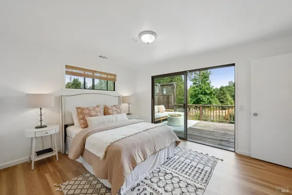 a bedroom with a bed and a night stand