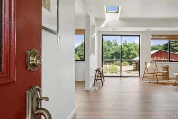 a view of a livingroom with furniture wooden floor and front door