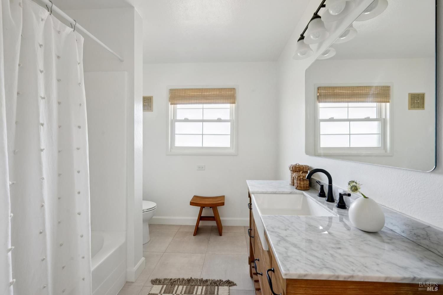 447 Sparkes Road Sebastopol, CA 95472 - Photo 23 of 44 a bathroom with a granite countertop sink a toilet and a bathtub