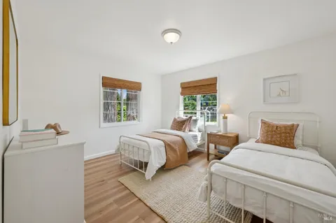 a bedroom with two beds and a window