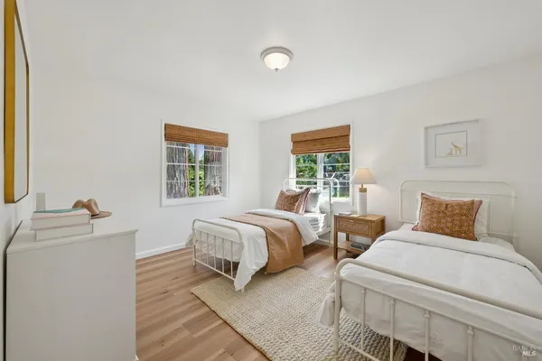 a bedroom with two beds and a window