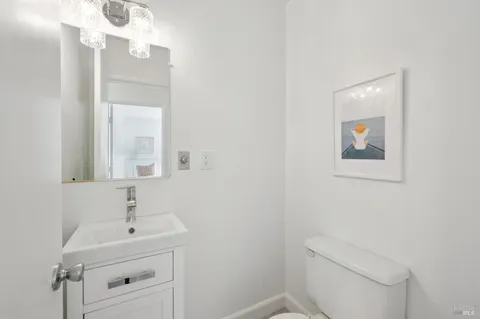 a bathroom with a sink mirror and toilet