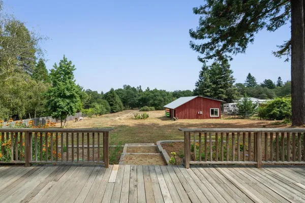 a view of a wooden deck and a yard