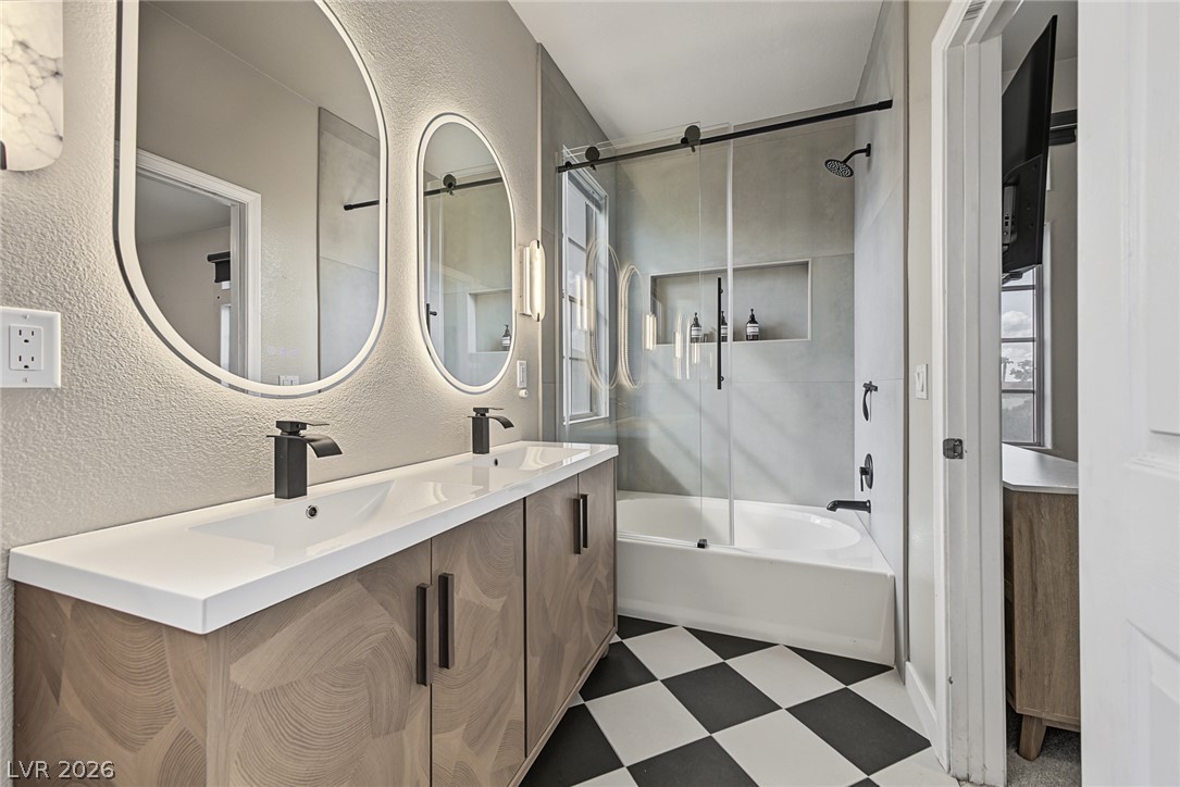 A stylish vanity paired with checkerboard flooring defines this contemporary bathroom space.