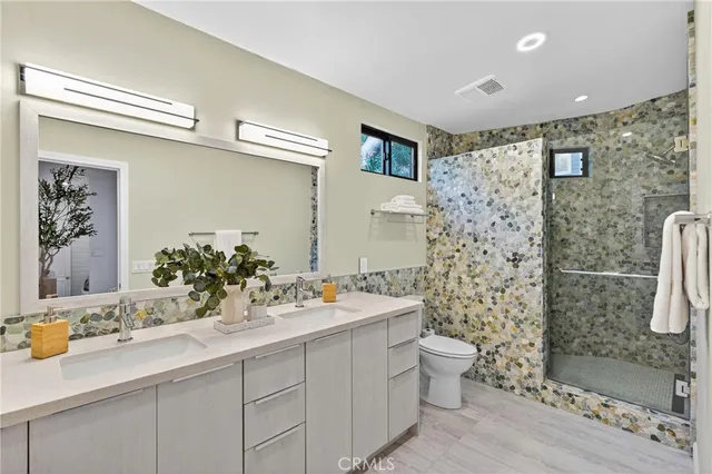 a bathroom with a sink mirror and toilet