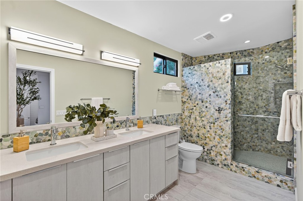 7576-7582 McGroarty Terrace Los Angeles, CA 91042 - Photo 12 of 47 a bathroom with a sink mirror and toilet