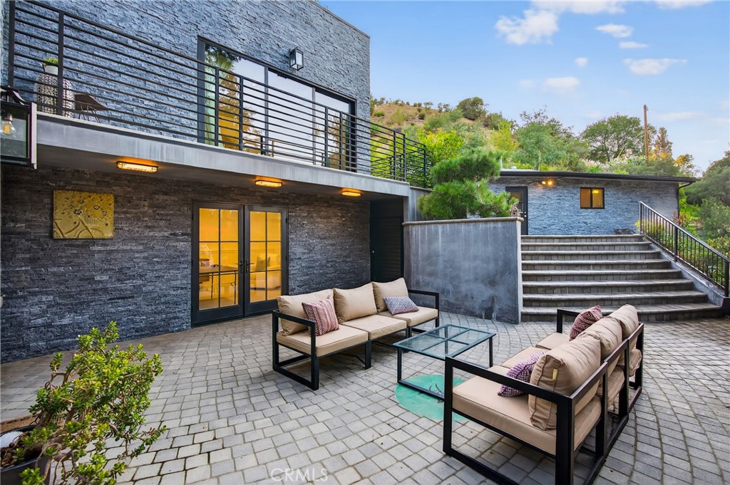 7576-7582 McGroarty Terrace Los Angeles, CA 91042 - Photo 23 of 47 a view of a patio with two couches and a potted plant