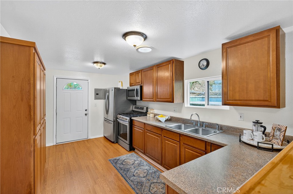 7576-7582 McGroarty Terrace Los Angeles, CA 91042 - Photo 26 of 47 a kitchen with stainless steel appliances granite countertop a sink stove and refrigerator