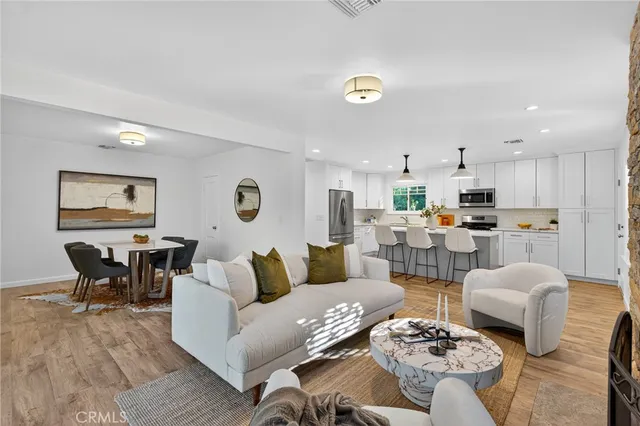 a living room with lots of furniture and kitchen view