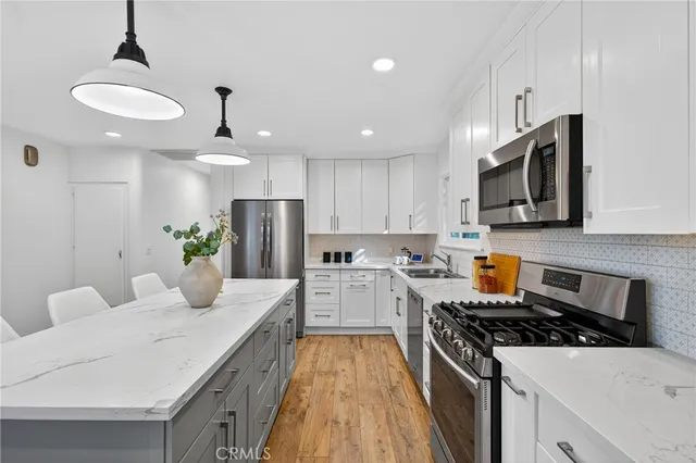 a kitchen with a stove a sink and a refrigerator