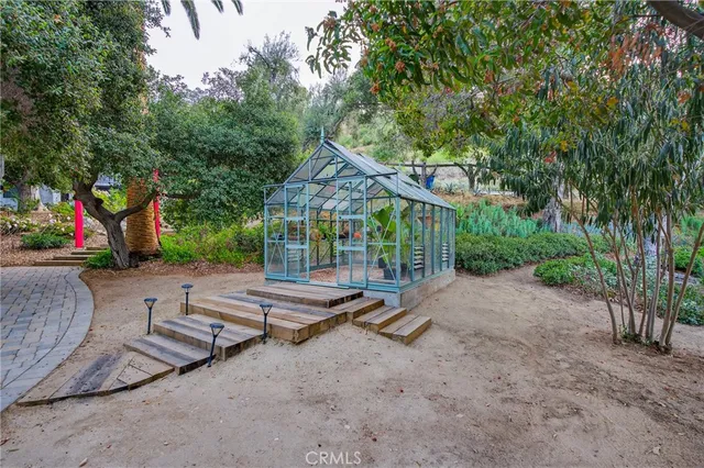 a backyard of a house with table and chairs