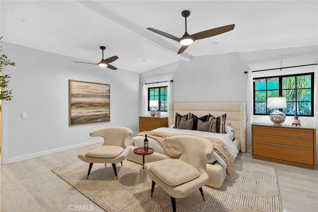 7576-7582 McGroarty Terrace Los Angeles, CA 91042 - Photo 10 of 47 a bedroom with a bed and a chandelier