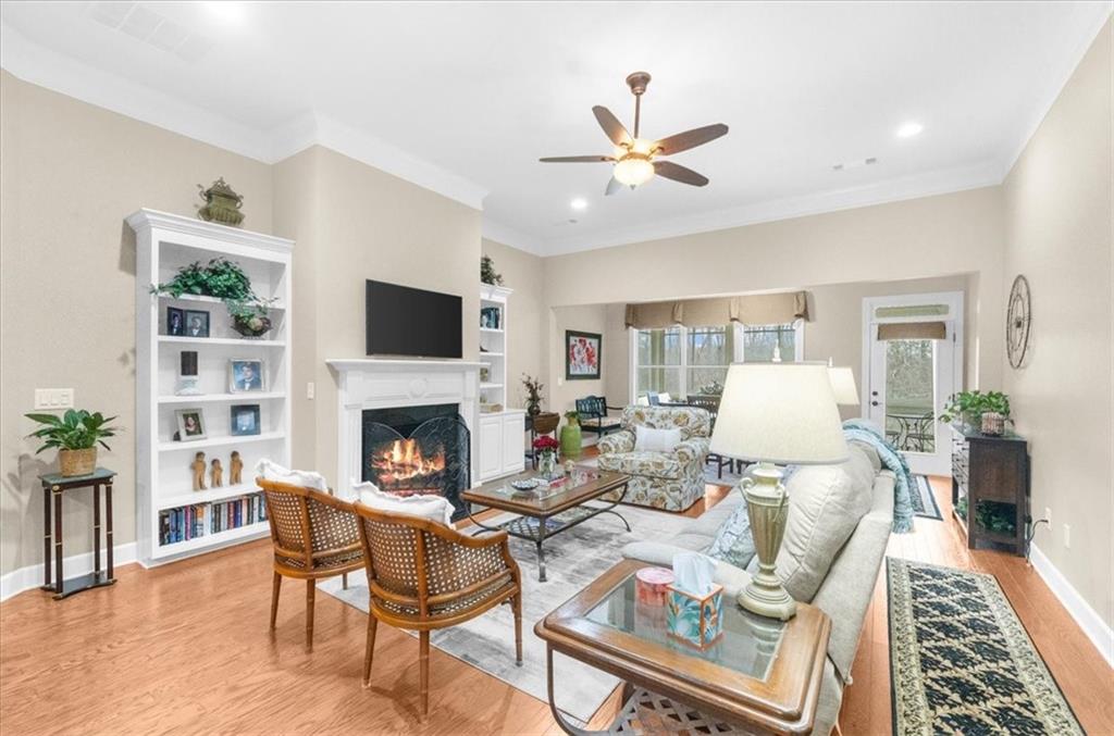 3357 Locust Cove Road Gainesville, GA 30504 - Photo 16 of 77 a living room with furniture a fireplace and a flat screen tv