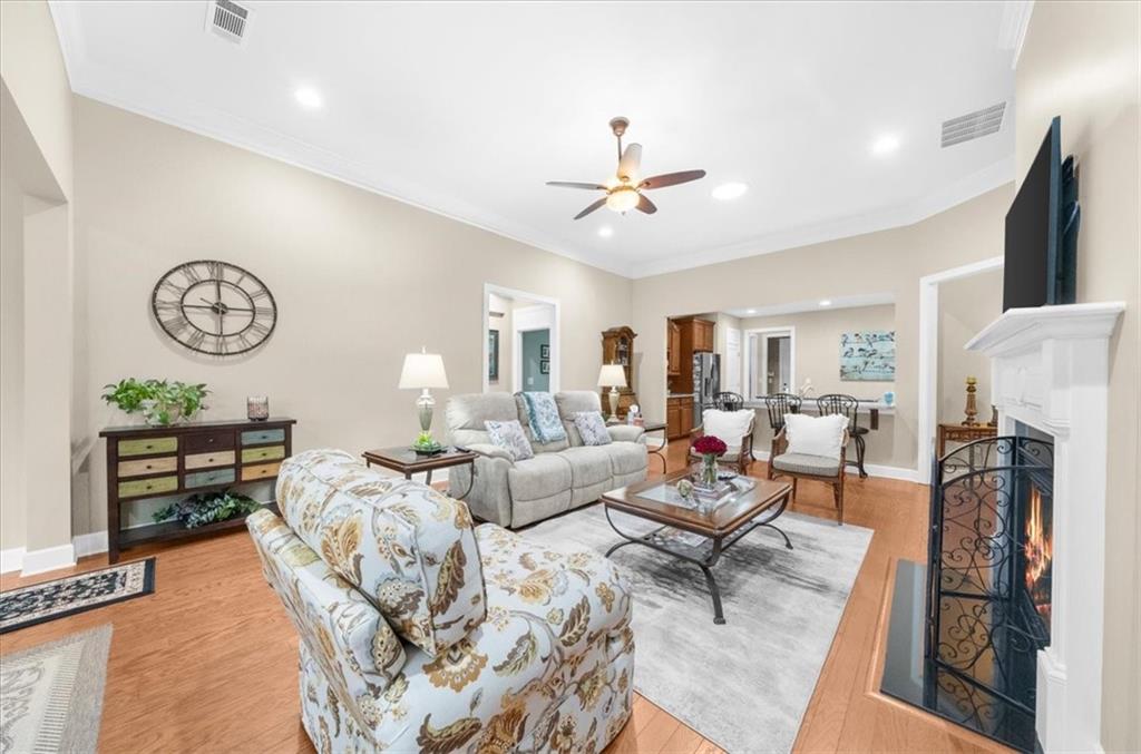 3357 Locust Cove Road Gainesville, GA 30504 - Photo 17 of 77 a living room with furniture a fireplace and a flat screen tv