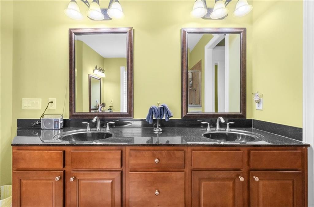 3357 Locust Cove Road Gainesville, GA 30504 - Photo 31 of 77 a bathroom with double sink and a mirror