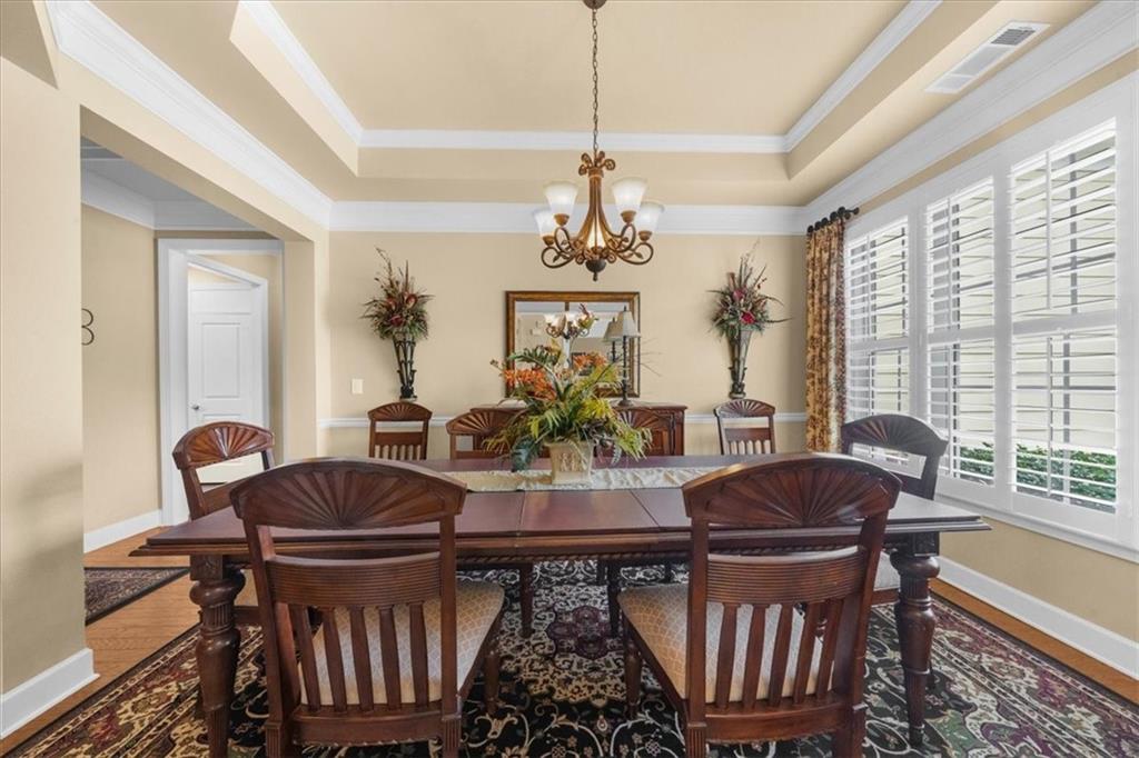 3357 Locust Cove Road Gainesville, GA 30504 - Photo 6 of 77 a living room with furniture a chandelier and a window