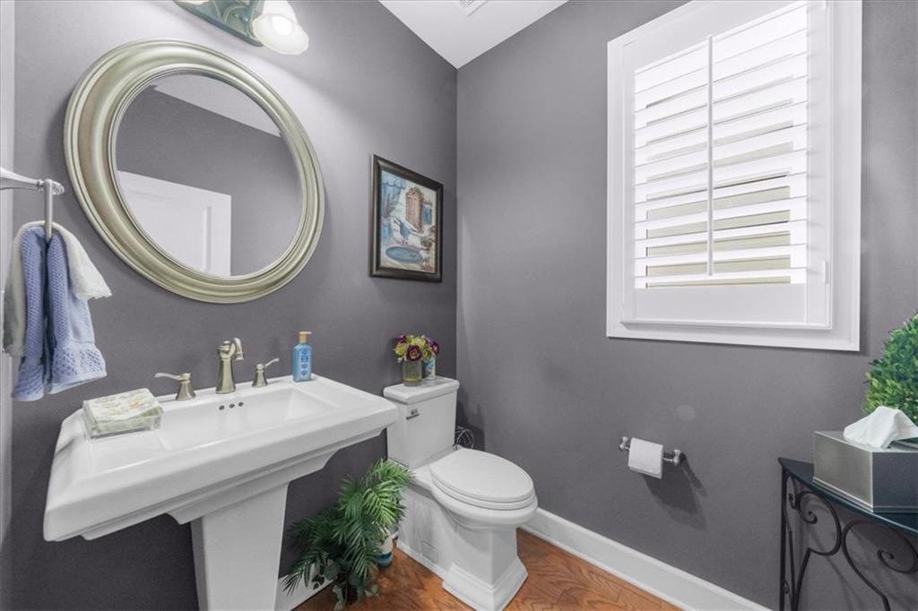 3357 Locust Cove Road Gainesville, GA 30504 - Photo 10 of 77 a bathroom with a toilet a sink and a mirror