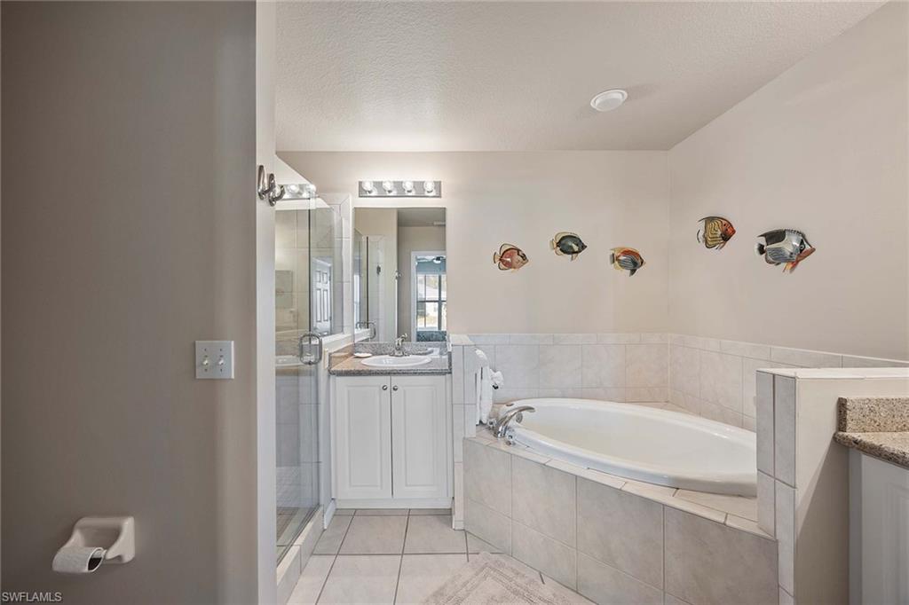 Undisclosed Address Naples, FL 34113 - Photo 14 of 38 a bathroom with a tub shower and sink