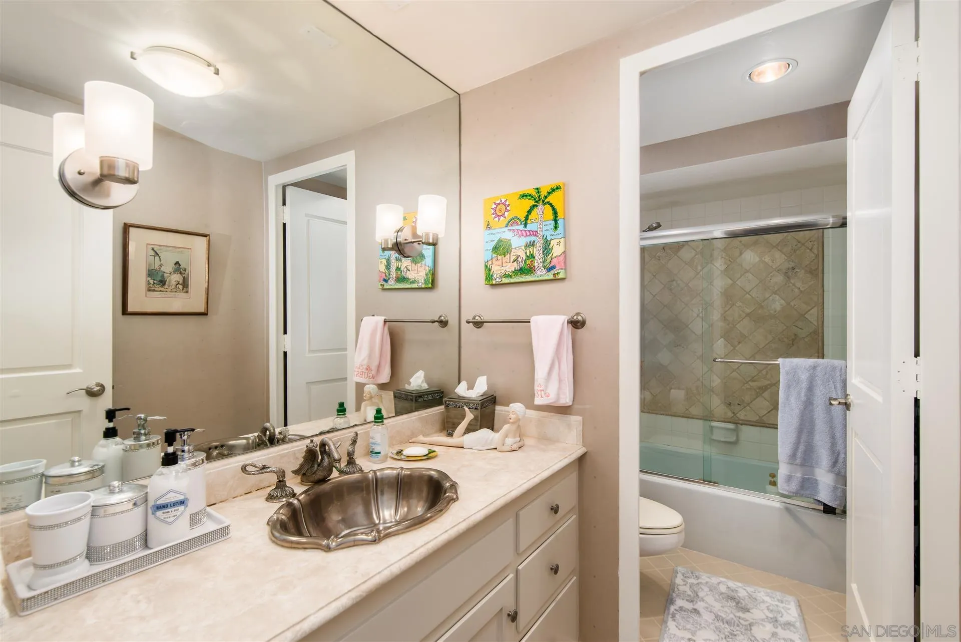 939 Coast Boulevard, Unit 16F La Jolla, CA 92037 - Photo 15 of 22 a bathroom with a sink a toilet and shower