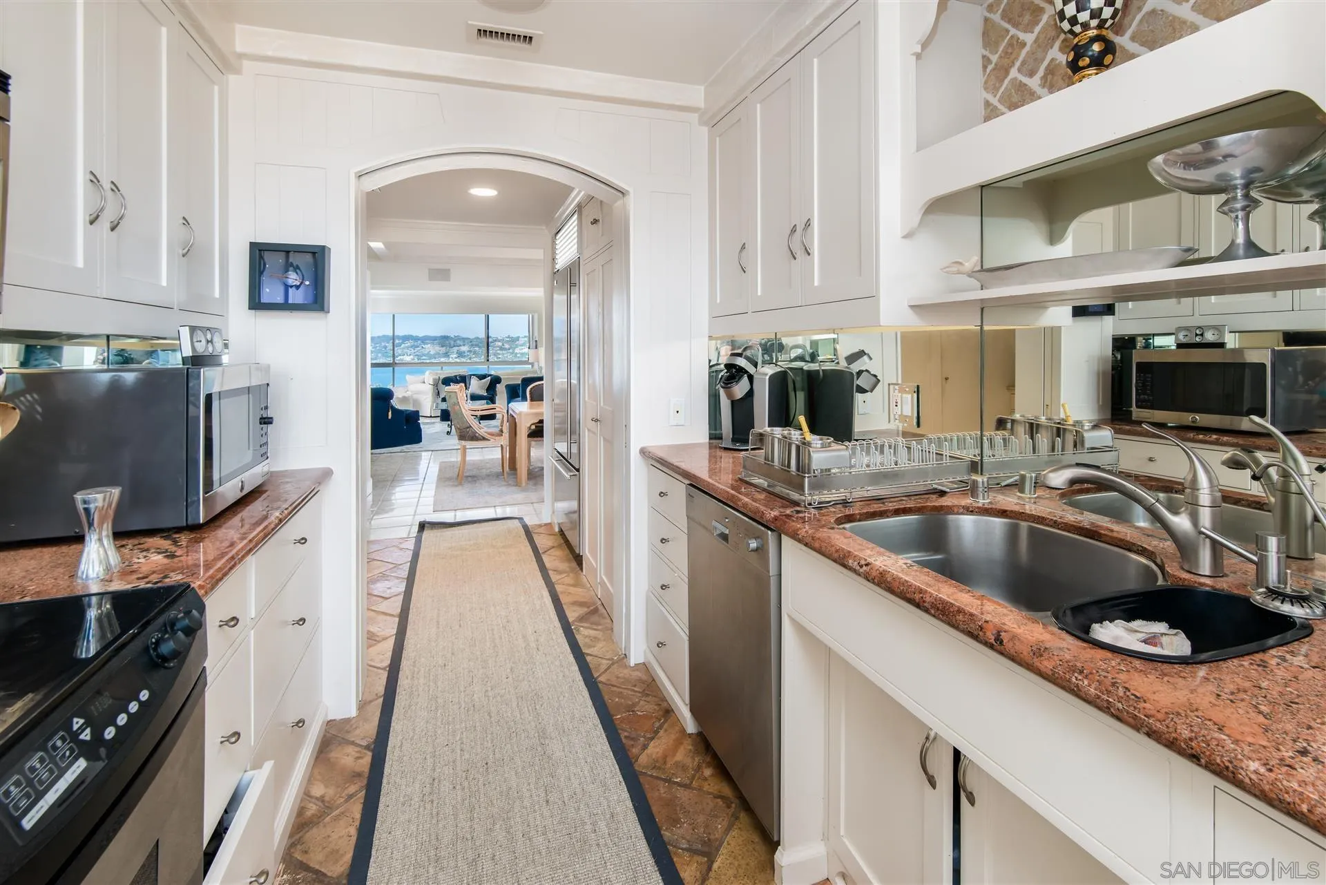 939 Coast Boulevard, Unit 16F La Jolla, CA 92037 - Photo 9 of 22 a kitchen with stainless steel appliances granite countertop a sink a stove and cabinets