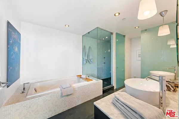 a bathroom with a tub sink and mirror