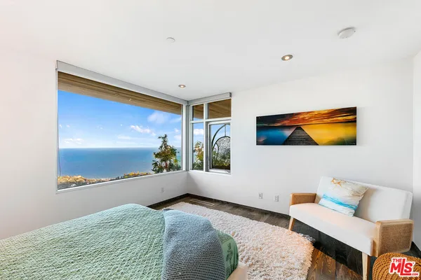 a bedroom with a bed and a night stand
