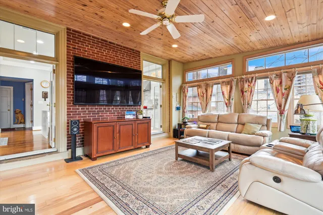 a living room with furniture a fireplace and a table