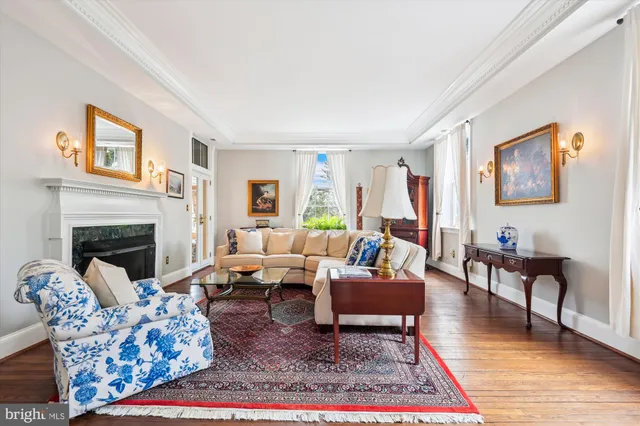 a living room with furniture a rug and a fireplace