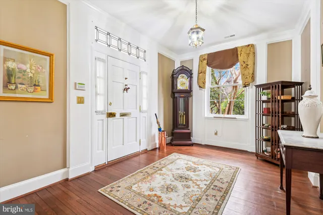 a livingroom with wooden floor and windows