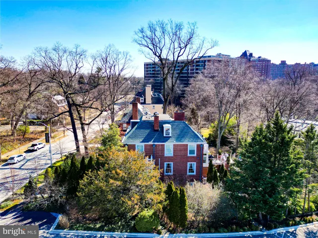 a front view of a house with yard and trees