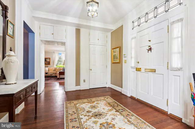 a view of a hallway with wooden floor and windows