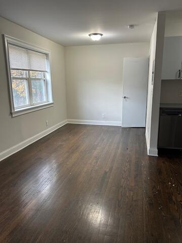 114 A Grove Street, Unit 2 Stamford, CT 06901 - Photo 3 of 10 an empty room with wooden floor cabinet and windows