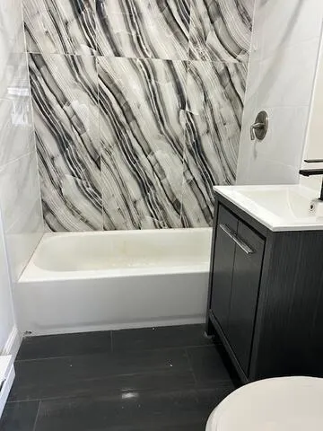 a bathroom with a bathtub and a sink