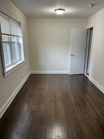 114 A Grove Street, Unit 2 Stamford, CT 06901 - Photo 10 of 10 an empty room with wooden floor and windows