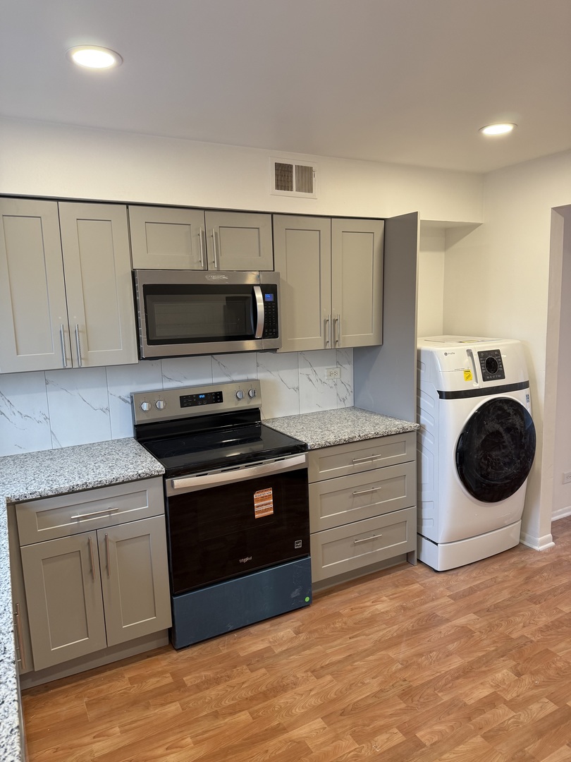 4208 Central Road, Unit 4F Glenview, IL 60025 - Photo 2 of 11 a kitchen with a stove and a microwave