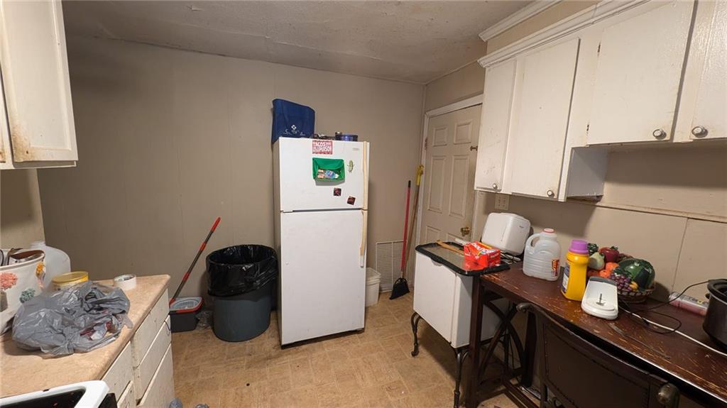 646 Straight Street Macon, GA 31204 - Photo 6 of 12 a kitchen with a refrigerator and a stove top oven
