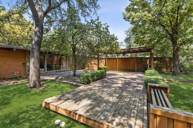 a view of backyard of house with green space