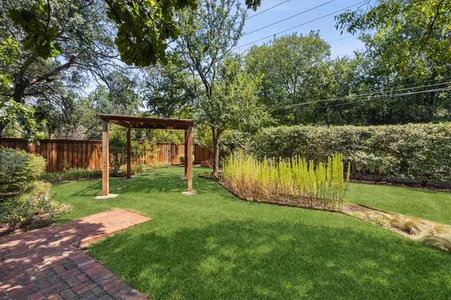 a view of a house with a backyard and a patio