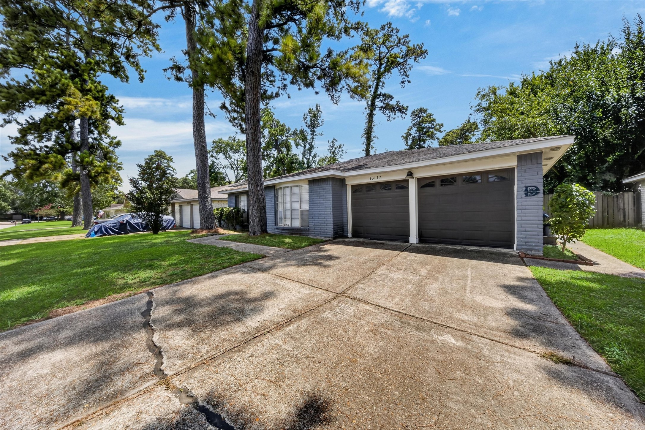 23127 Harpergate Drive Spring, TX 77373 - Photo 6 of 26 Extended driveway and detached garage provide abundant parking and storage options.