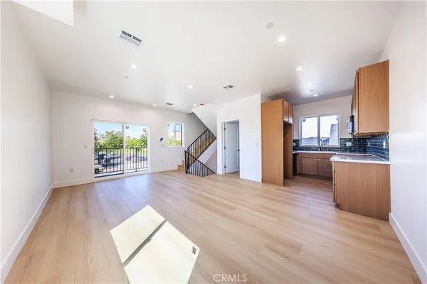 a view of a living room a kitchen and a wooden floor