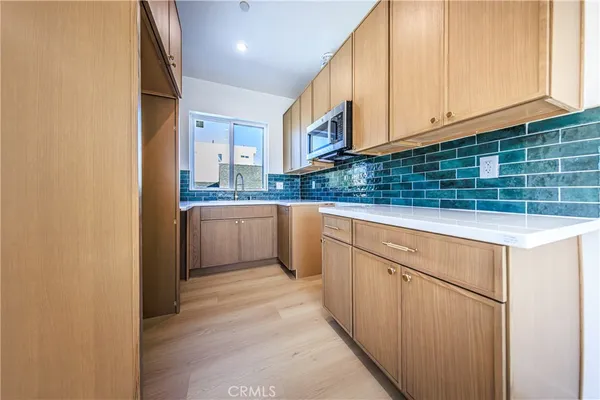 a kitchen with stainless steel appliances granite countertop a sink and cabinets