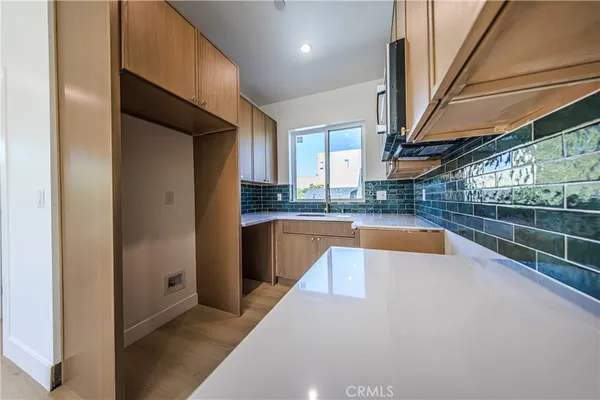 a view of kitchen with granite countertop cabinets and a sink