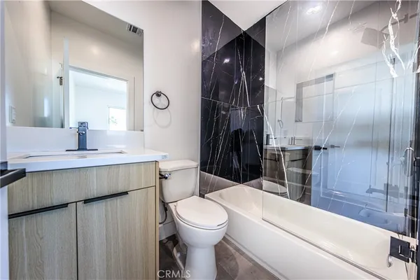 a bathroom with a toilet sink and shower