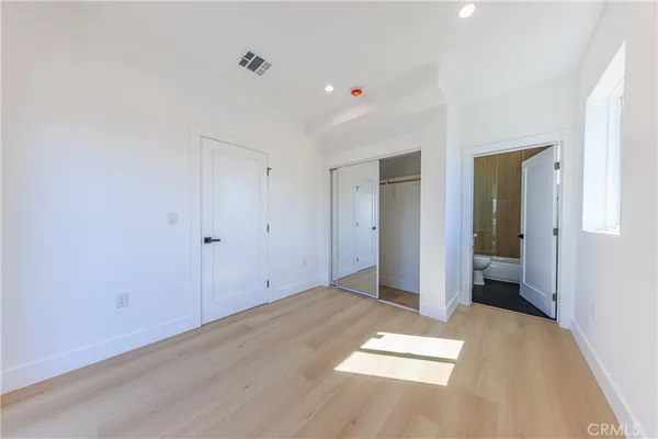 a view of hallway with a bathroom