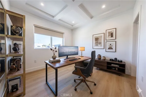 a view of a workspace with furniture and a window