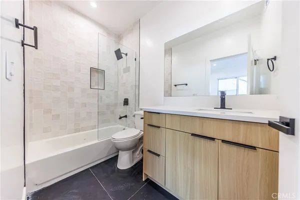 a bathroom with a double vanity sink toilet and shower