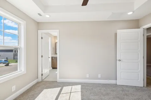 an empty room with windows and entrance